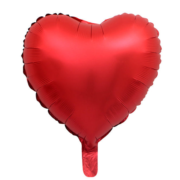 Shiny red heart-shaped foil balloon with a smooth reflective surface and small inflation tab at the bottom.